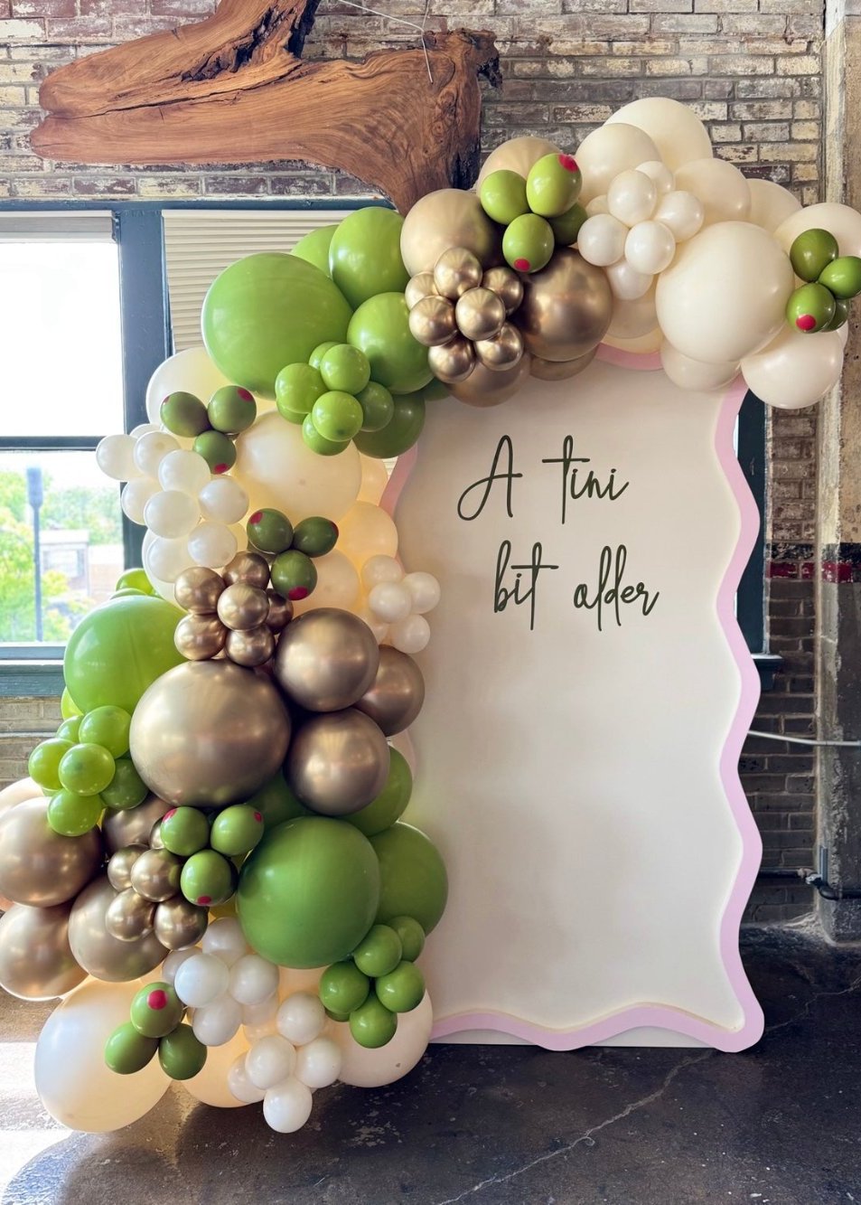 Olive themed balloon backdrop for a 40th birthday