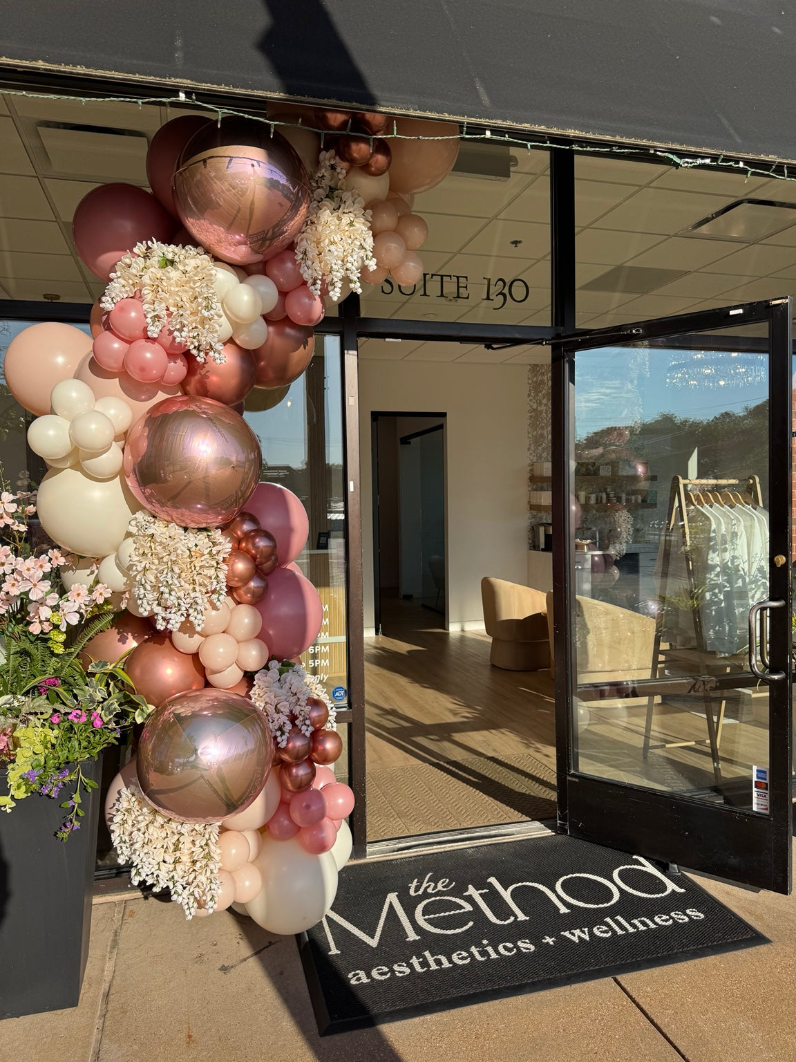 Party Hop floral balloon storefront installation at The Method Aesthetics and Wellness